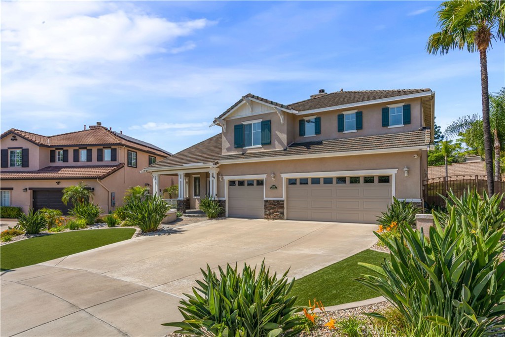 33351 Nicholas Common Temecula, CA 92592 - Photo 6 of 42 a front view of a house with a garden and plants