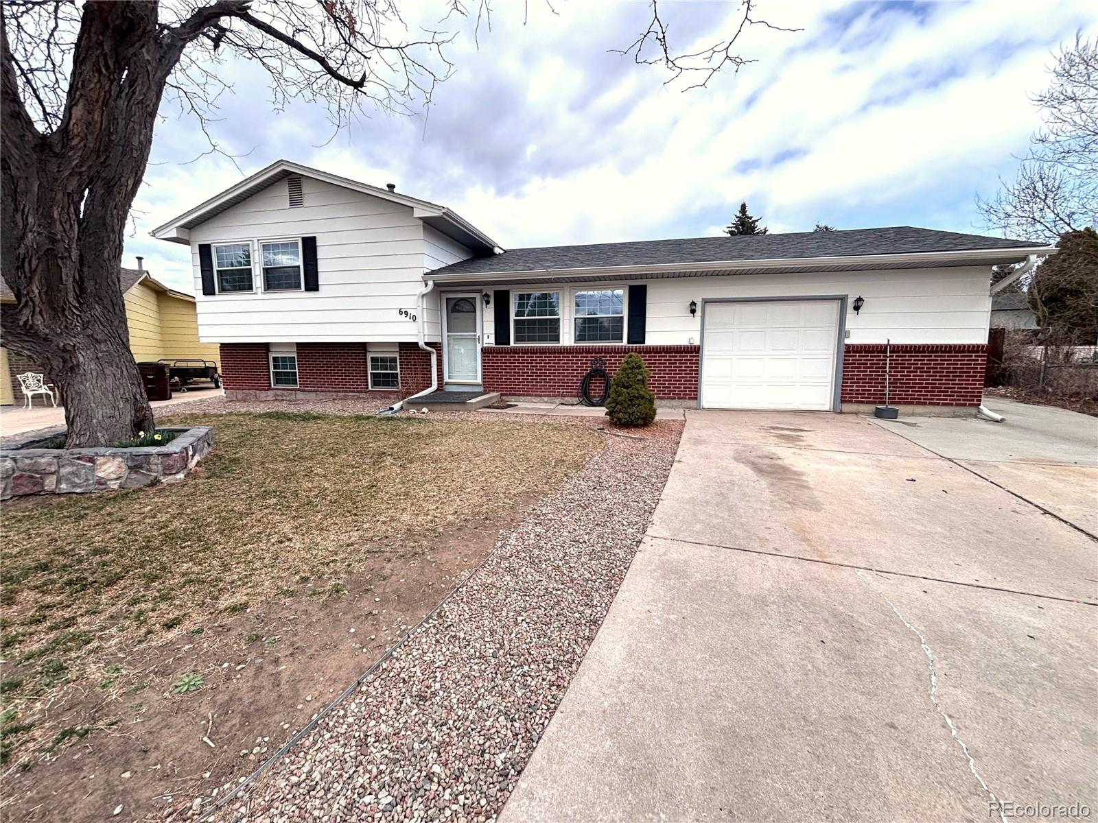 a view of a house with a yard and sitting area