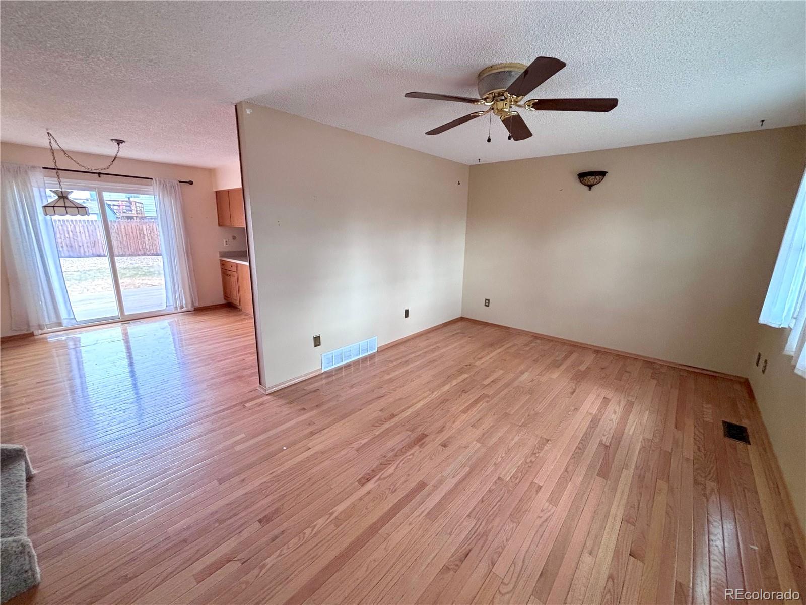 6910 Roaring Spring Terrace Fountain, CO 80817 - Photo 2 of 14 a view of empty room with wooden floor and fan