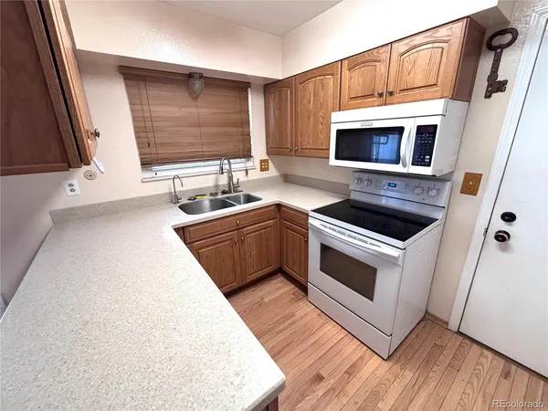 a kitchen with stainless steel appliances a stove a sink and a microwave