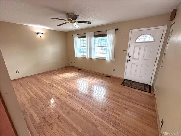 wooden floor in an empty room with a window
