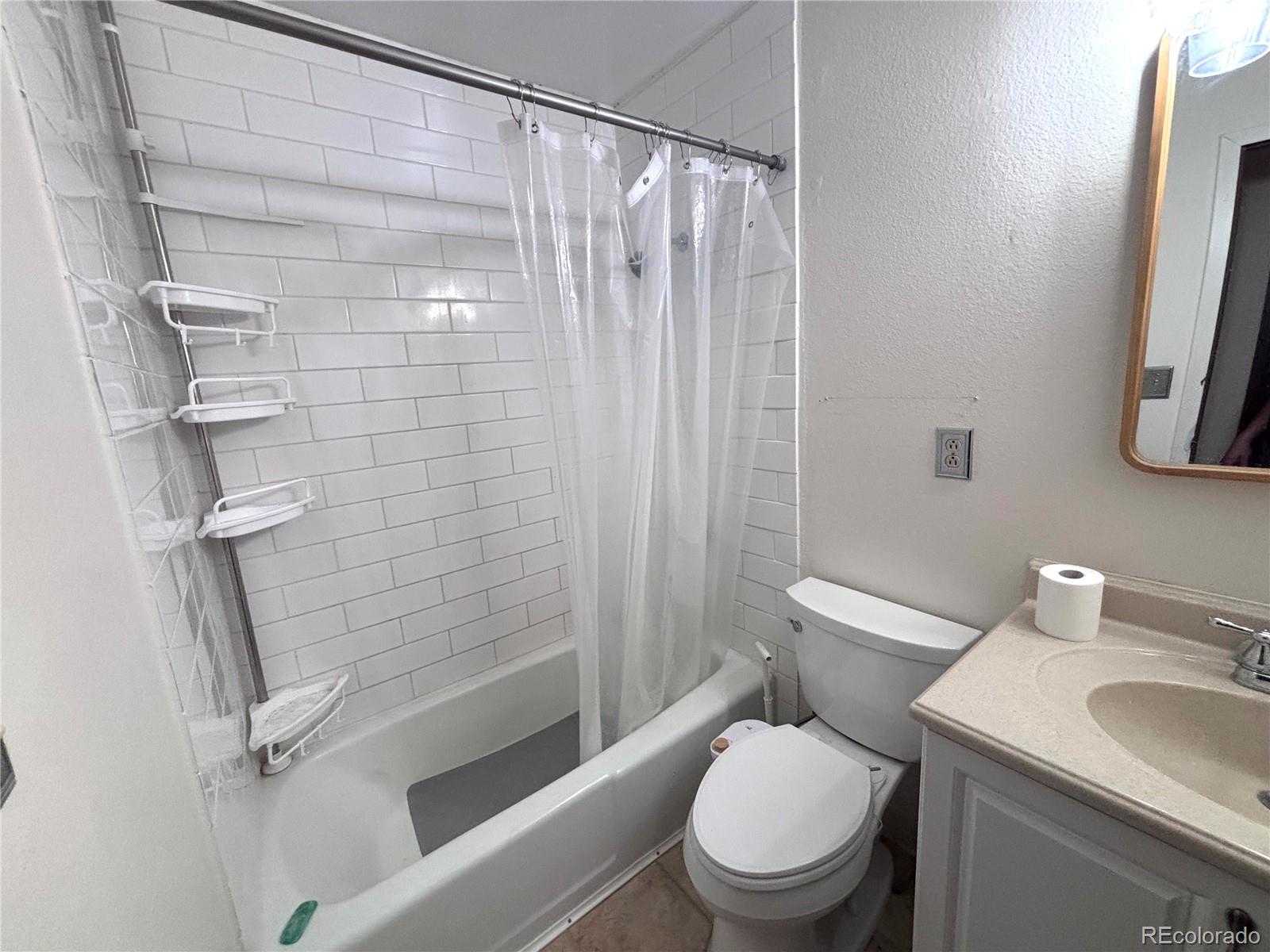 6910 Roaring Spring Terrace Fountain, CO 80817 - Photo 8 of 14 a white toilet sitting next to a bath tub