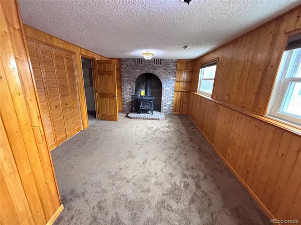 a view of empty room with window and fireplace