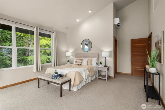 a bed room with a bed and a flat tv screen