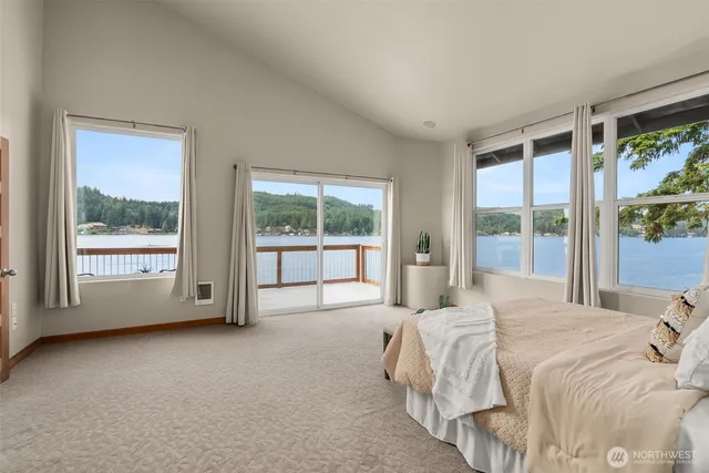 a large bed sitting in a bedroom next to a window