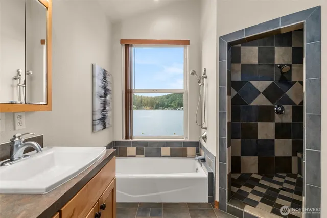 a bathroom with a tub sink and shower