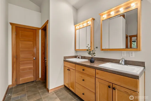 a bathroom with a granite countertop sink mirror and