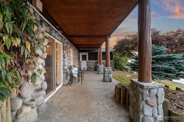 a view of a porch with chairs and backyard