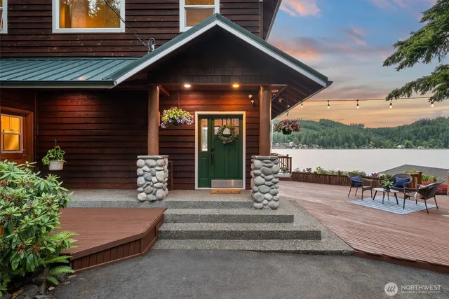 a front view of a house with garden and plants