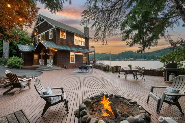 a view of a patio with table and chairs potted plants and a large tree