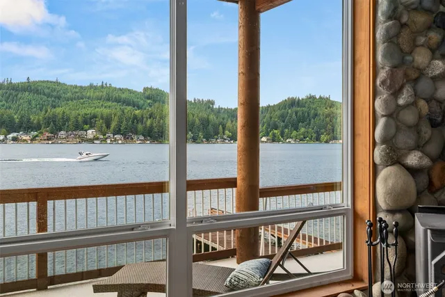 a view of a balcony with chairs and floor to ceiling window