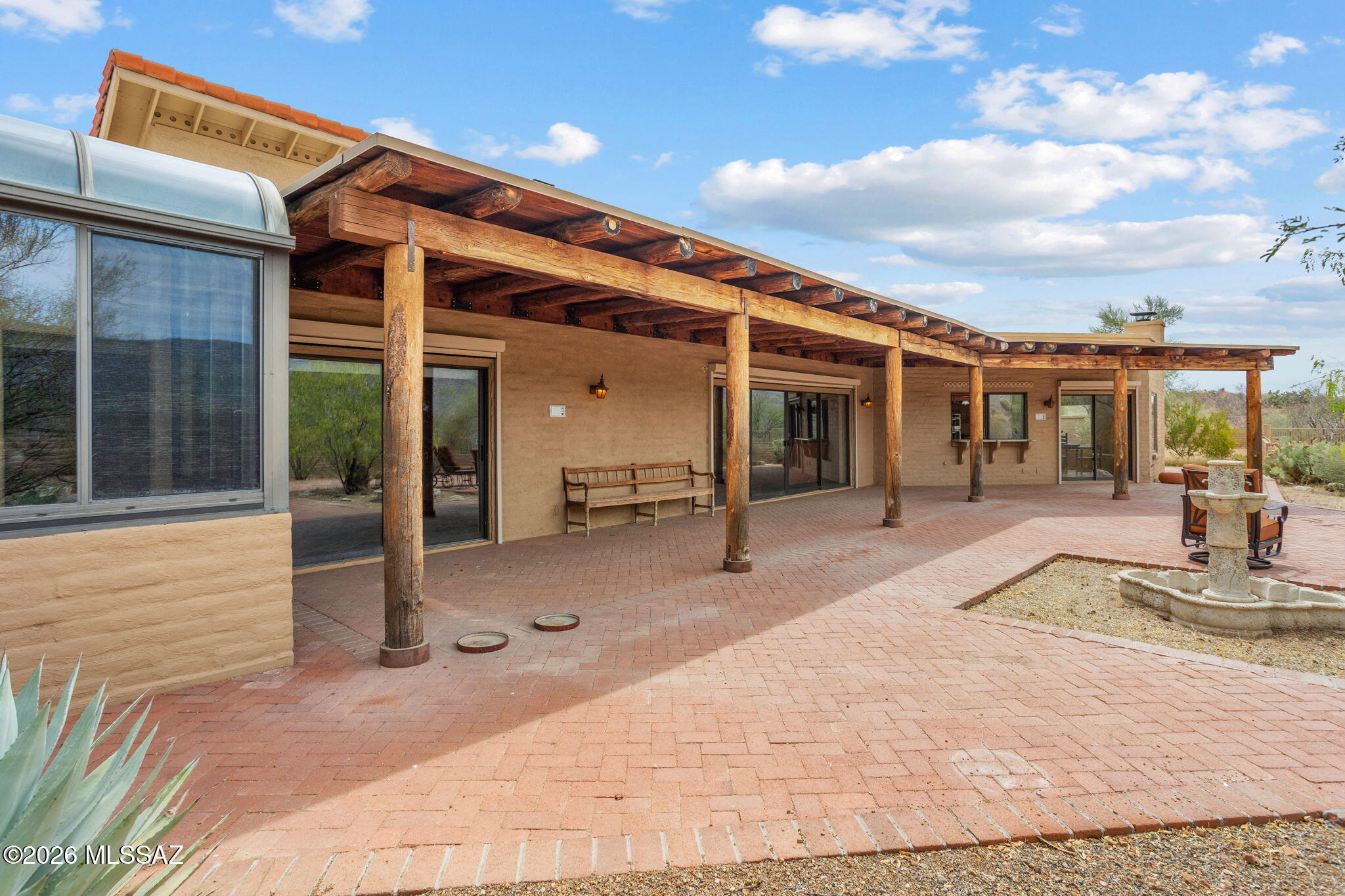 7171 South X9 Ranch Road Vail, AZ 85641 - Photo 45 of 50 Sunroom to kitchen door. Pavered patio. Bench not included.