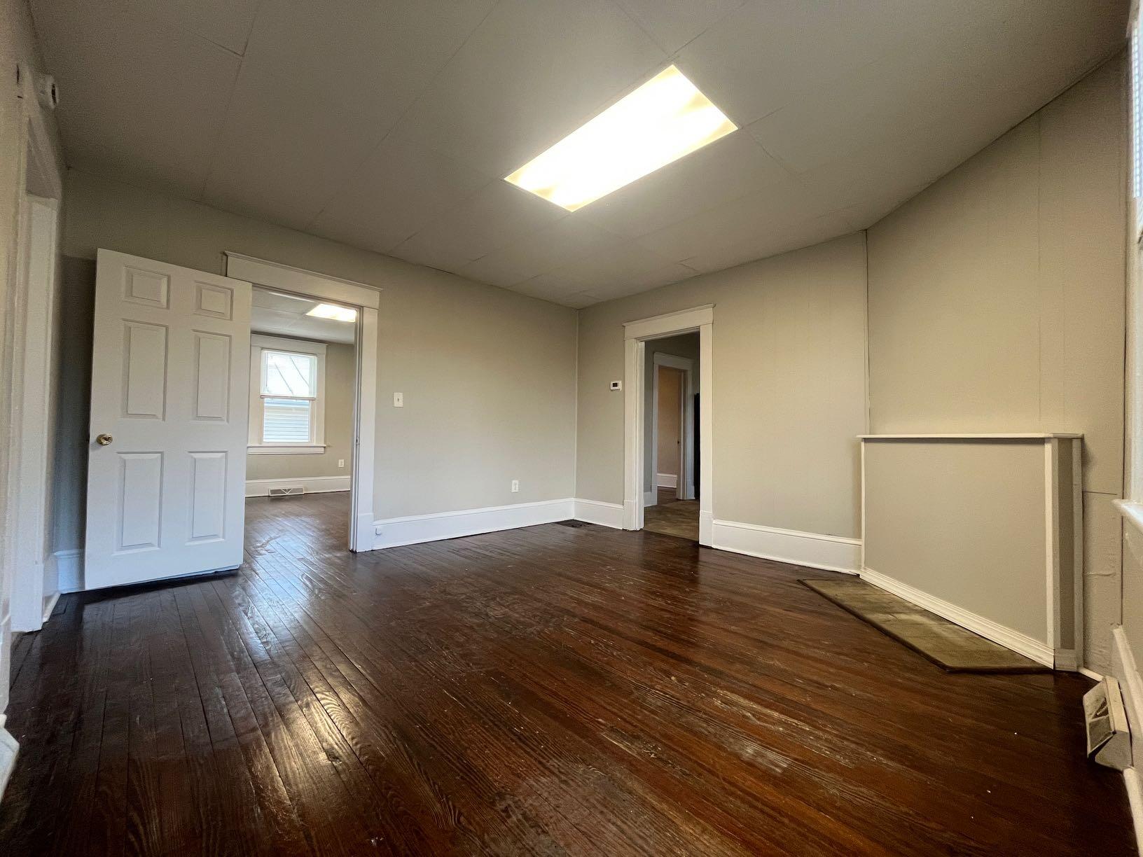 3641 Yellow Mountain Road Southeast Roanoke, VA 24014 - Photo 3 of 12 an empty room with wooden floor and windows