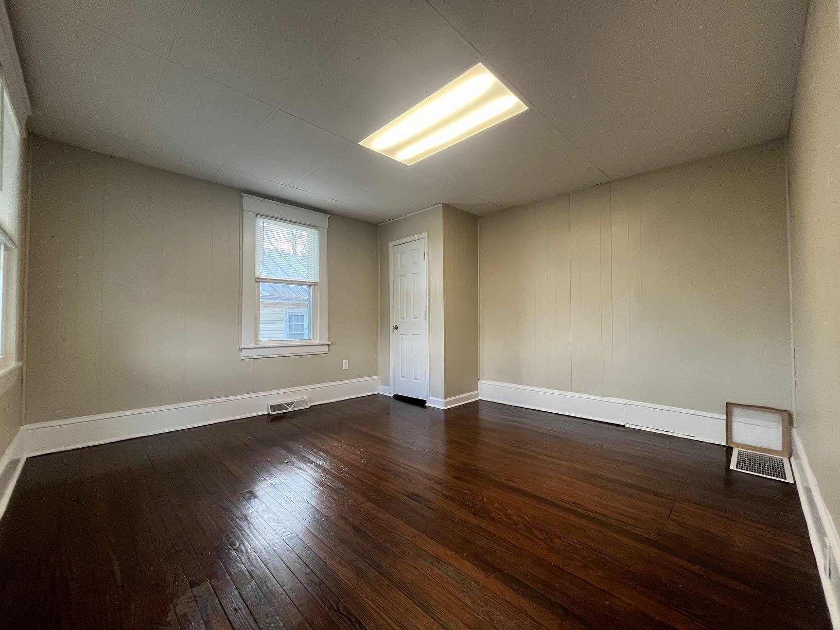 3641 Yellow Mountain Road Southeast Roanoke, VA 24014 - Photo 6 of 12 a view of an empty room with wooden floor and a window