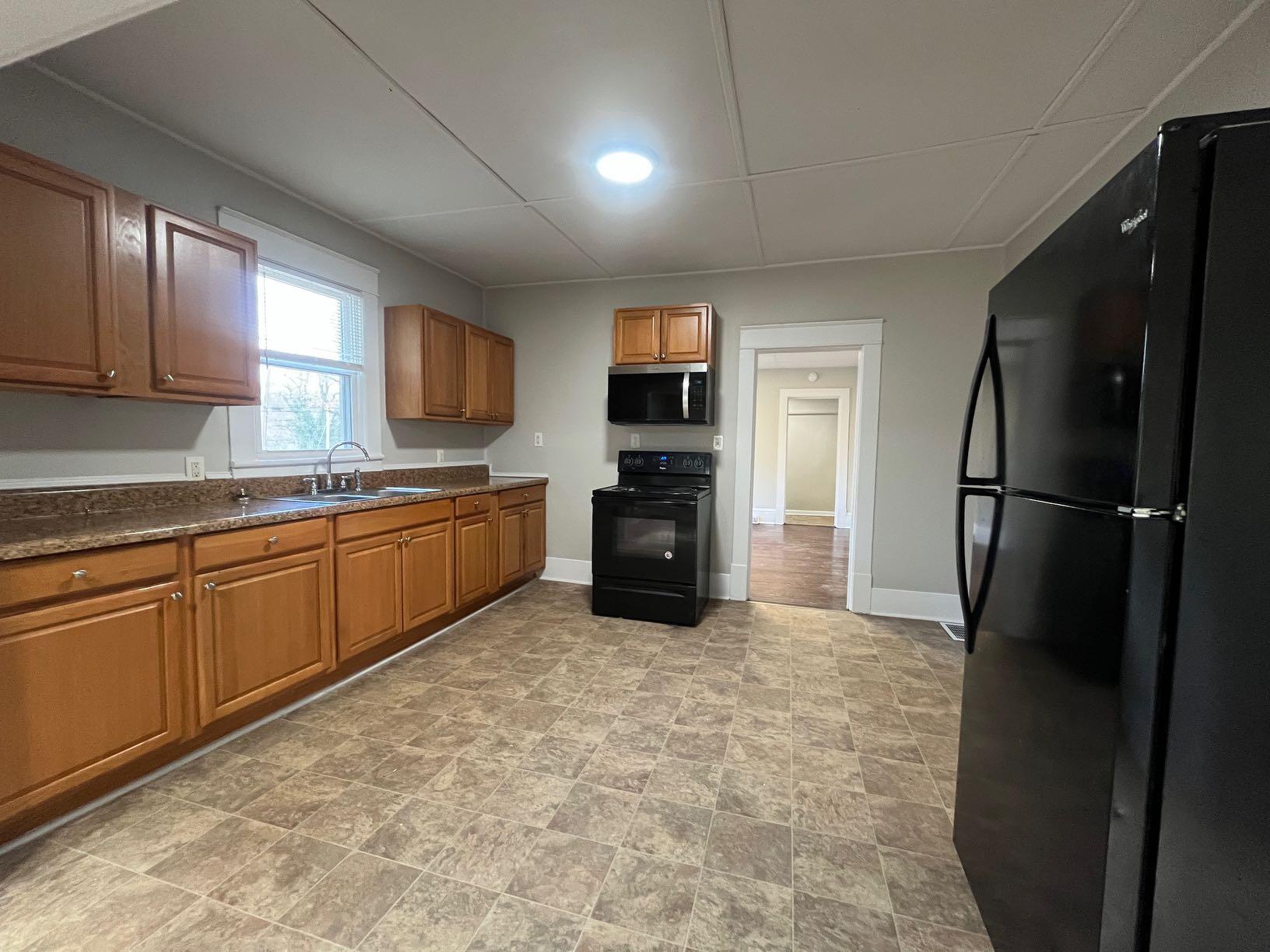 3641 Yellow Mountain Road Southeast Roanoke, VA 24014 - Photo 9 of 12 a kitchen with a refrigerator and a sink