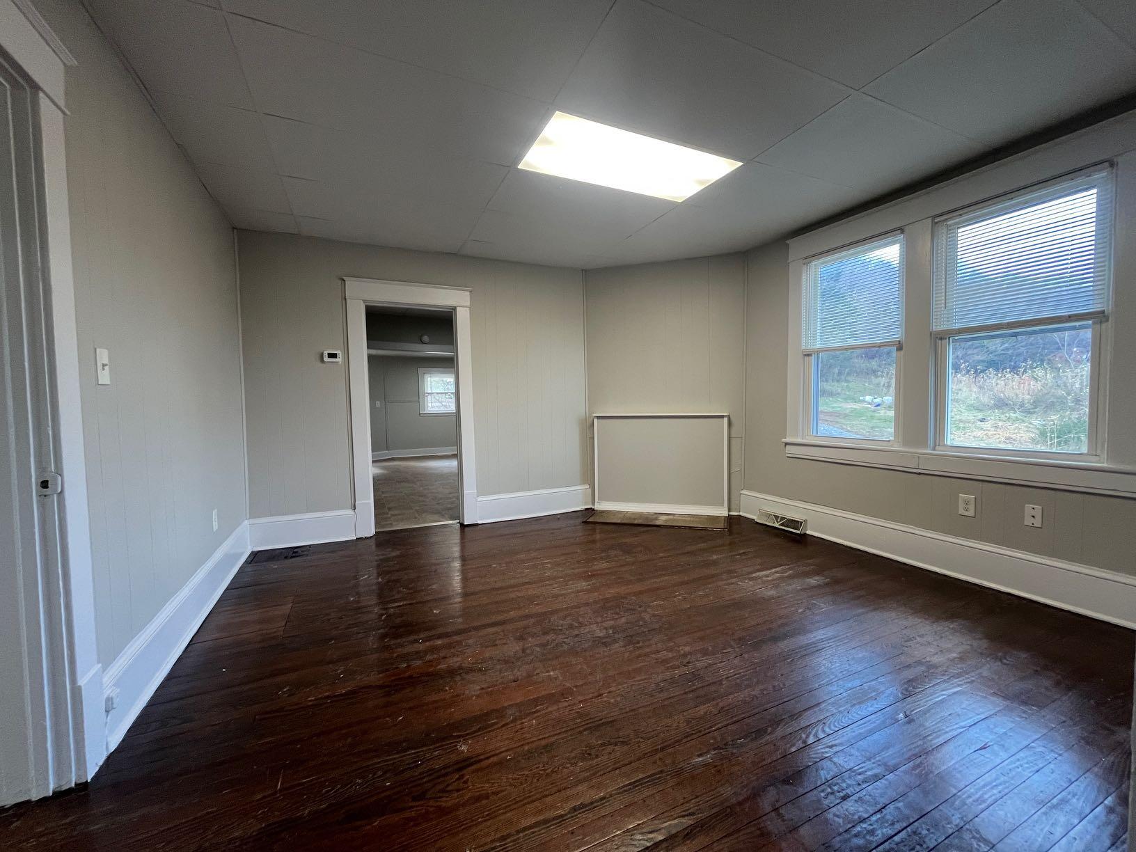 3641 Yellow Mountain Road Southeast Roanoke, VA 24014 - Photo 10 of 12 an empty room with wooden floor and windows