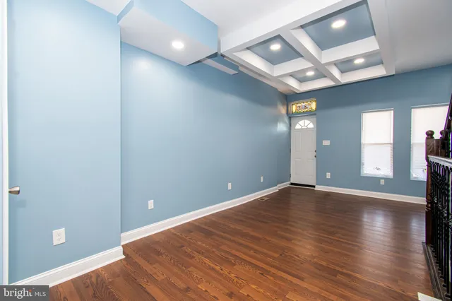 a view of cabinets a sink wooden floor and a window