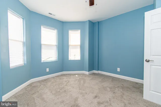 a view of a hallway with closet and wooden floor
