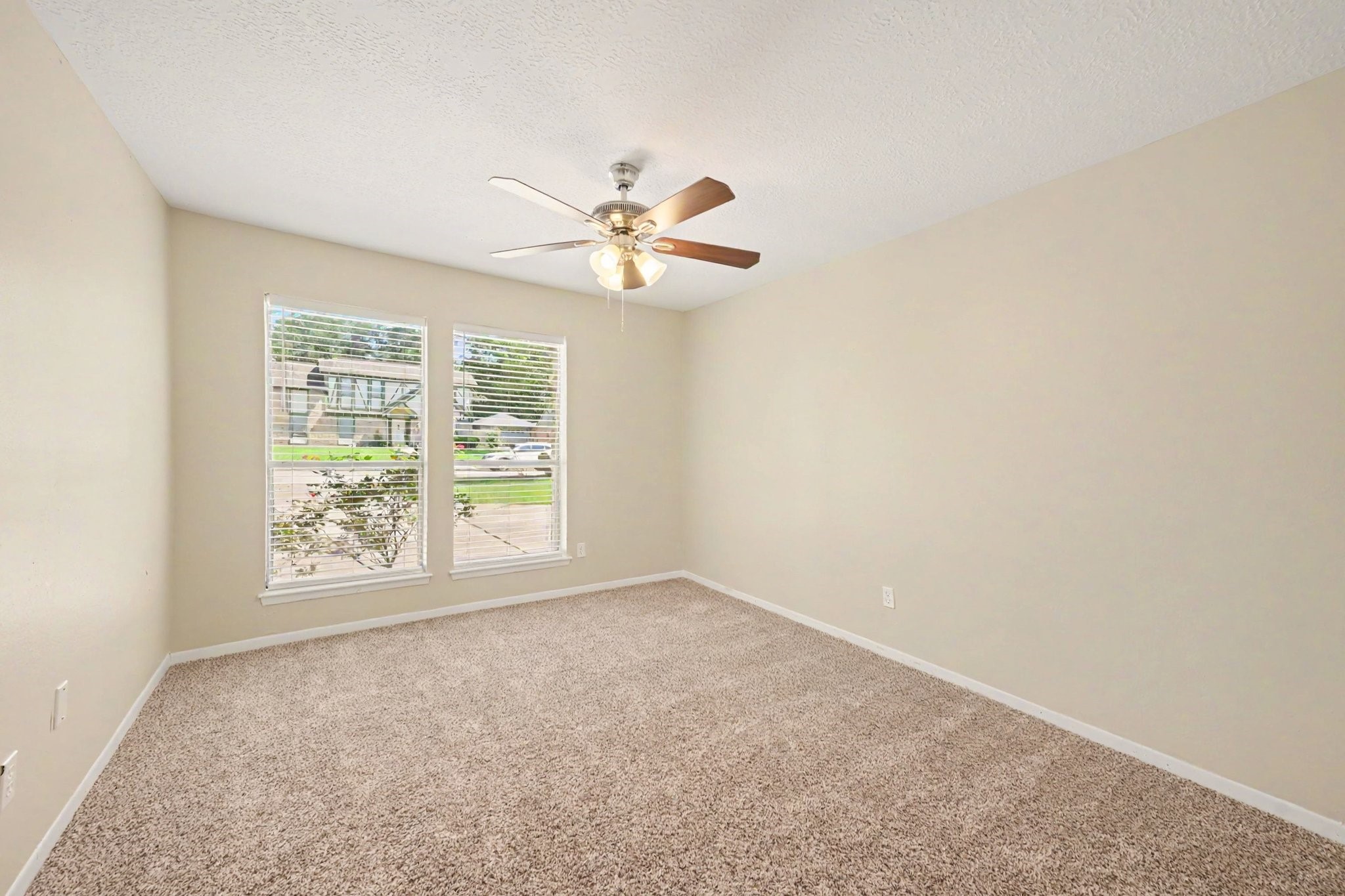 17419 Cassina Drive Spring, TX 77388 - Photo 23 of 35 an empty room with windows and fan