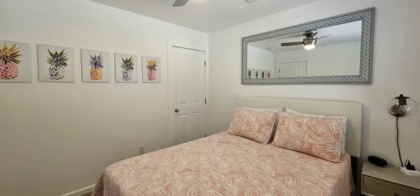 a bedroom with a bed and a wall painting