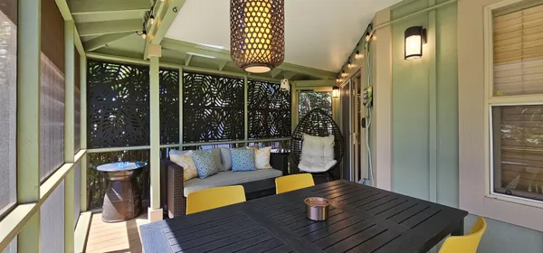 a view of balcony with furniture and wooden floor