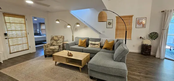 a living room with furniture and wooden floor