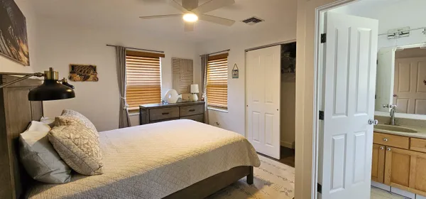 a bedroom with a bed and glass windows