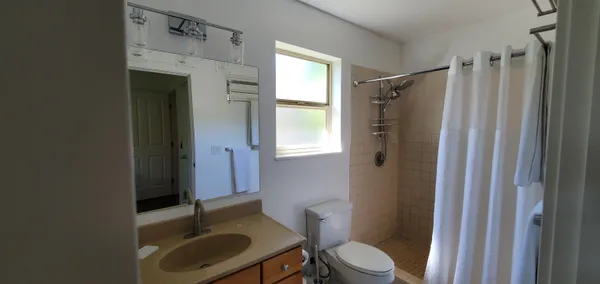 a bathroom with a sink toilet and shower