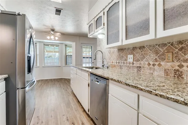 a kitchen with a stove and a white cabinet