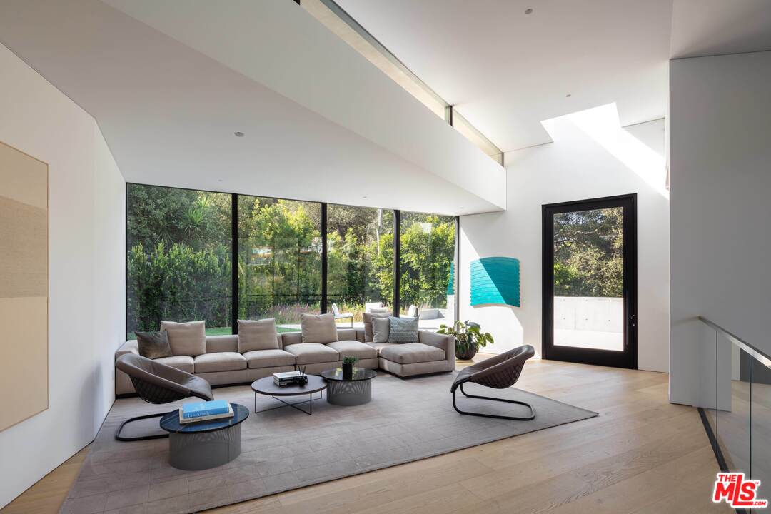 2600 Hutton Drive Beverly Hills, CA 90210 - Photo 13 of 29 a living room with furniture and floor to ceiling windows