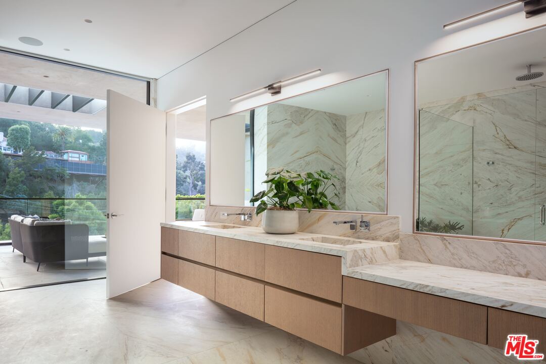 2600 Hutton Drive Beverly Hills, CA 90210 - Photo 21 of 29 a bathroom with a granite countertop sink mirror and a shower