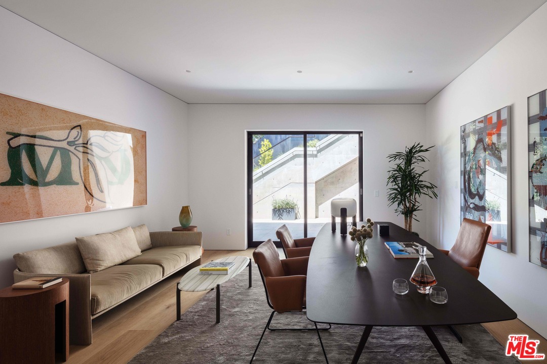 2600 Hutton Drive Beverly Hills, CA 90210 - Photo 27 of 29 a living room with furniture two large window and wooden floor