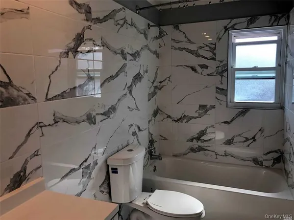 a bathroom with a sink toilet and bathtub