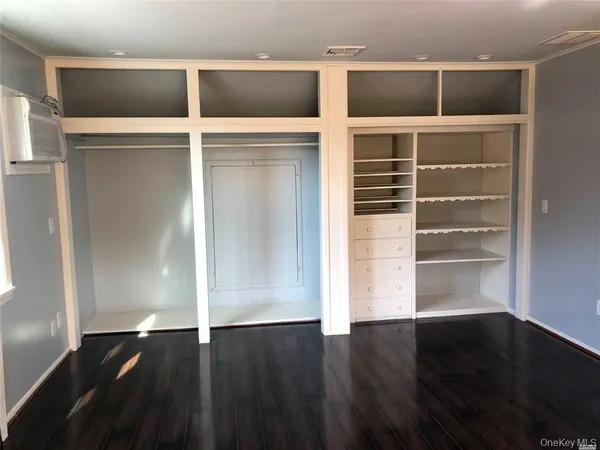 a view of walk in closet with empty racks