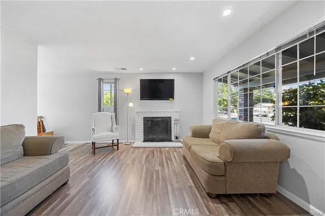 a living room with furniture a fireplace and a flat screen tv