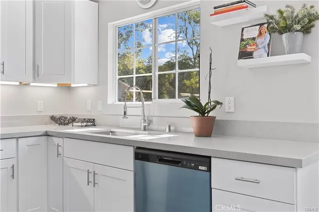 a kitchen with a sink and cabinets