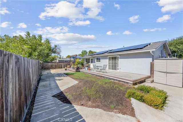 a view of a house with backyard and sitting area