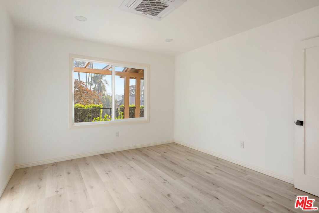 347 North Rampart Boulevard Los Angeles, CA 90026 - Photo 11 of 24 an empty room with wooden floor and windows
