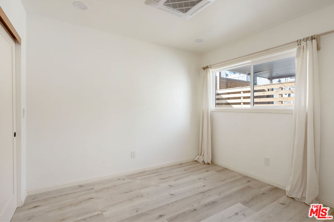 347 North Rampart Boulevard Los Angeles, CA 90026 - Photo 14 of 24 an empty room with wooden floor and windows