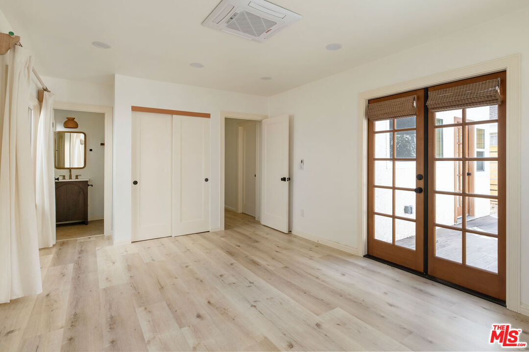 347 North Rampart Boulevard Los Angeles, CA 90026 - Photo 17 of 24 wooden floor in an empty room with a window