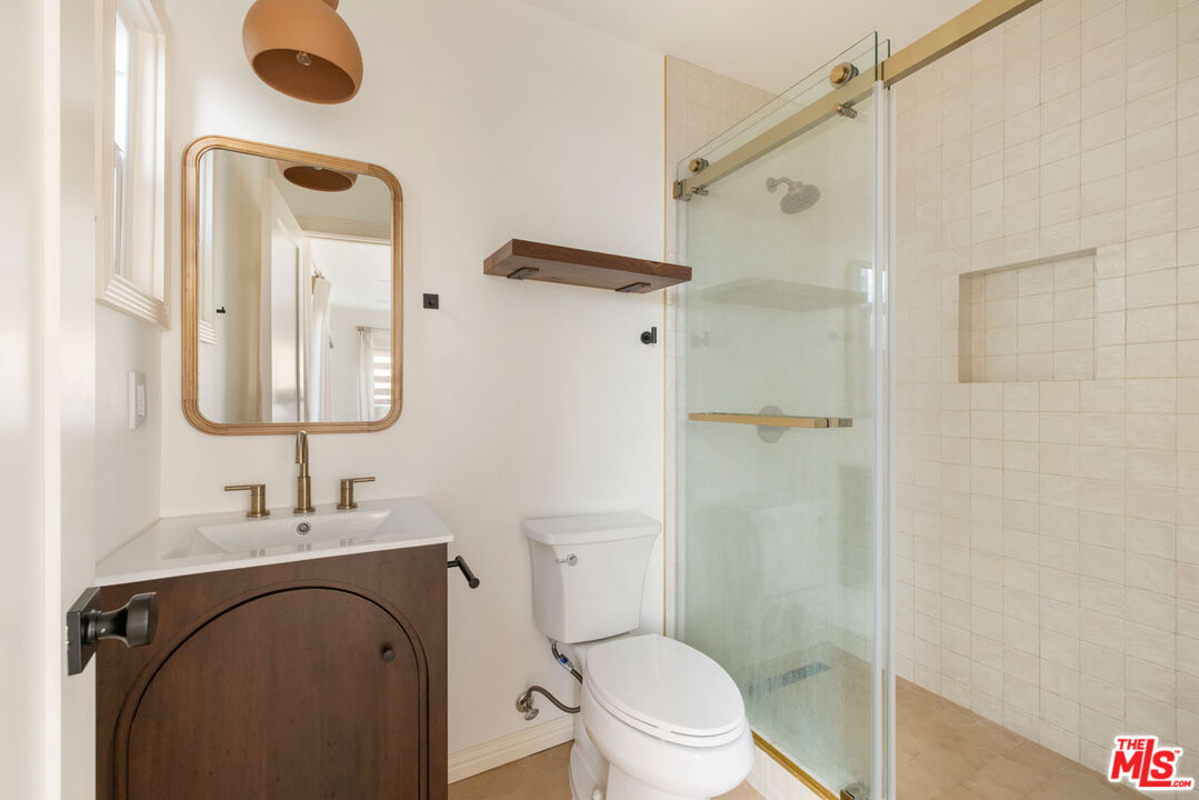 347 North Rampart Boulevard Los Angeles, CA 90026 - Photo 18 of 24 a bathroom with a granite countertop sink toilet and shower