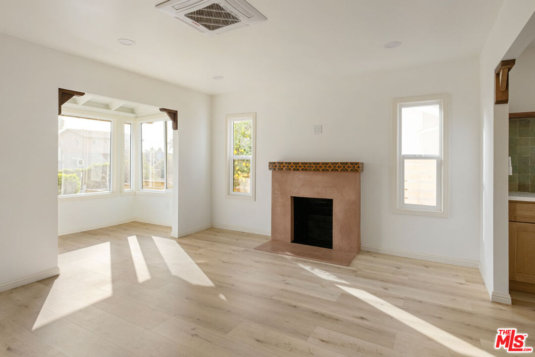347 North Rampart Boulevard Los Angeles, CA 90026 - Photo 4 of 24 an empty room with windows and fireplace
