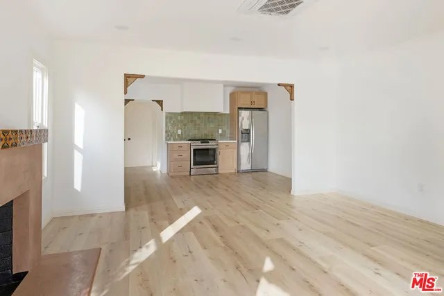 a view of a kitchen with a sink and a refrigerator