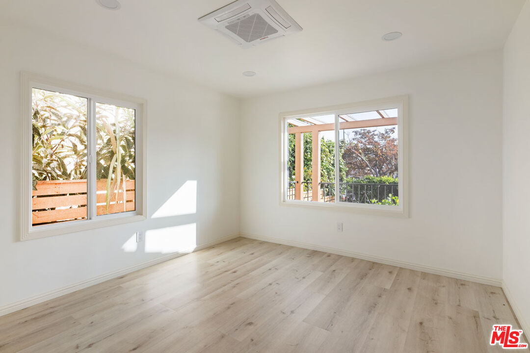 347 North Rampart Boulevard Los Angeles, CA 90026 - Photo 10 of 24 an empty room with wooden floor and windows