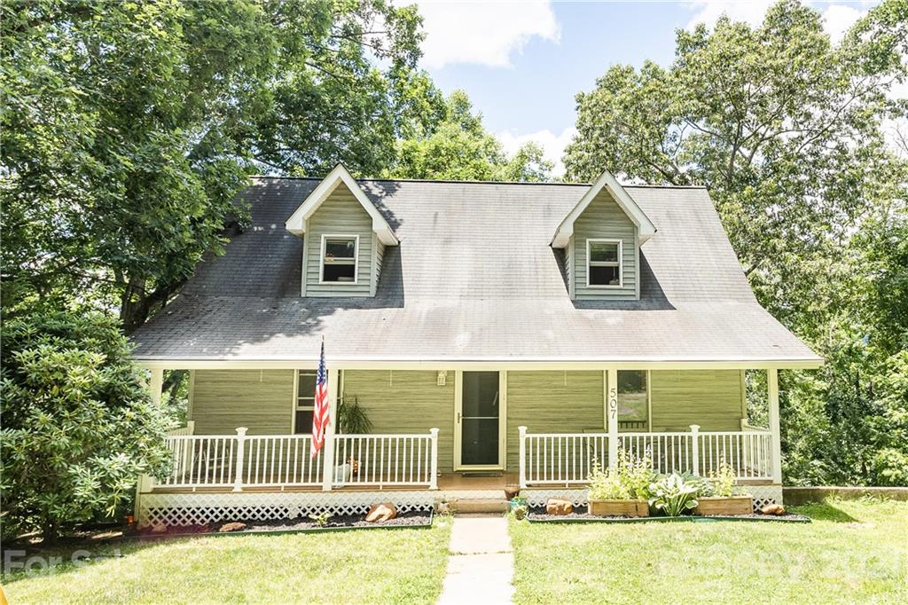 507 Vision Road Canton, NC 28716 - Photo 2 of 39 a front view of a house with a garden and plants
