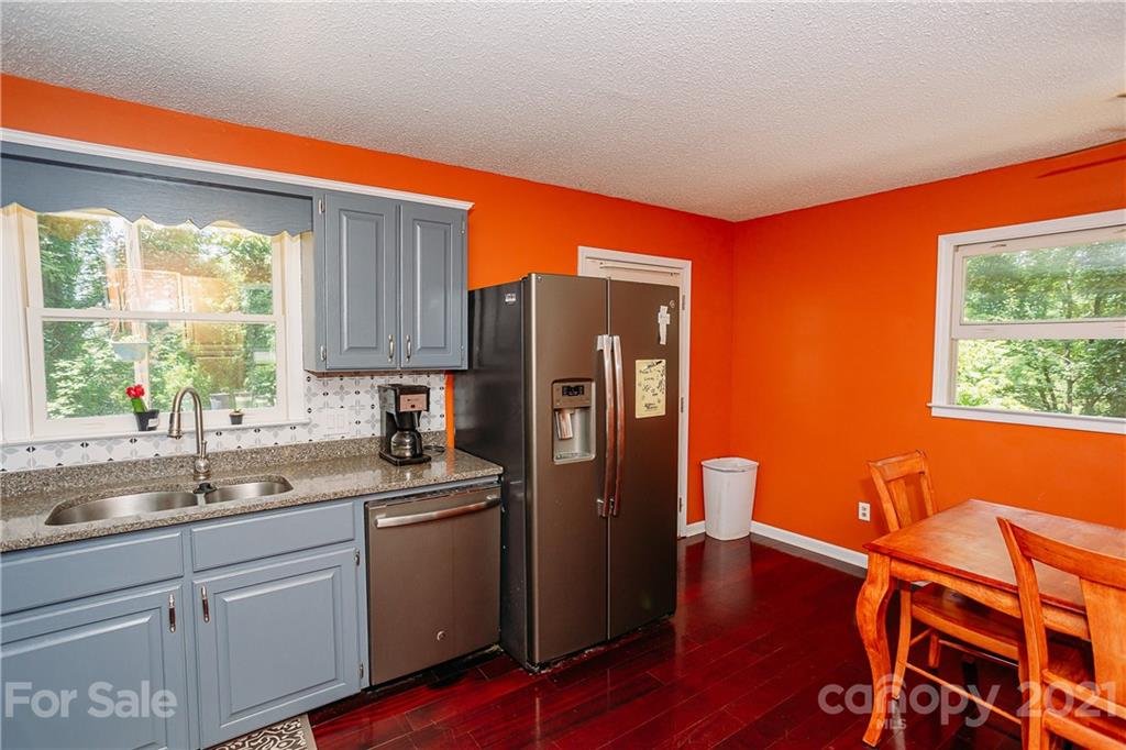 507 Vision Road Canton, NC 28716 - Photo 11 of 39 a kitchen with stainless steel appliances granite countertop a refrigerator sink and wooden cabinets
