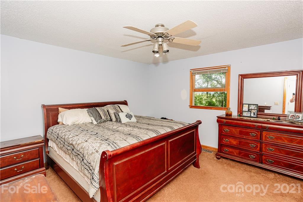 507 Vision Road Canton, NC 28716 - Photo 15 of 39 a bed room with a bed and a window