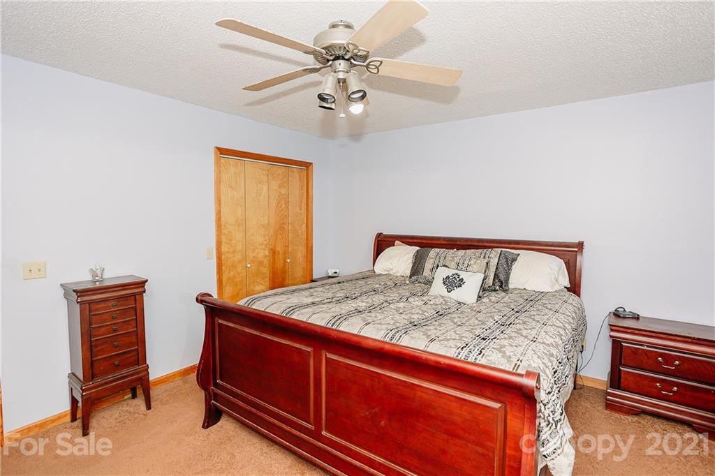 507 Vision Road Canton, NC 28716 - Photo 16 of 39 a bed sitting in a bedroom next to a window