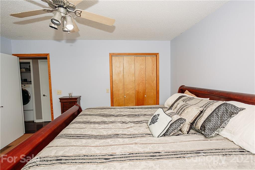 507 Vision Road Canton, NC 28716 - Photo 17 of 39 a bedroom with a bed and wooden floor