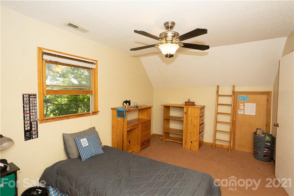 507 Vision Road Canton, NC 28716 - Photo 21 of 39 a bedroom with furniture and a window